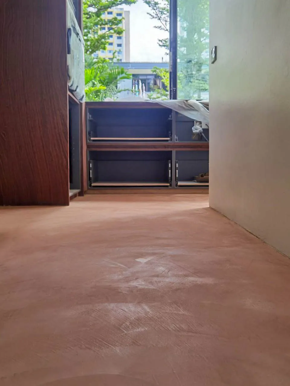 Terracotta-coloured IFS MicroCrete microcement floor in a home